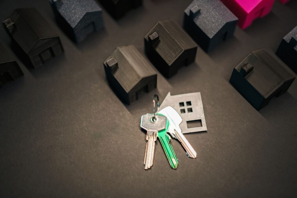 Crafting Captivating Headlines: Your awesome post title goes here Miniature house models and keys symbolize real estate investment and housing market.