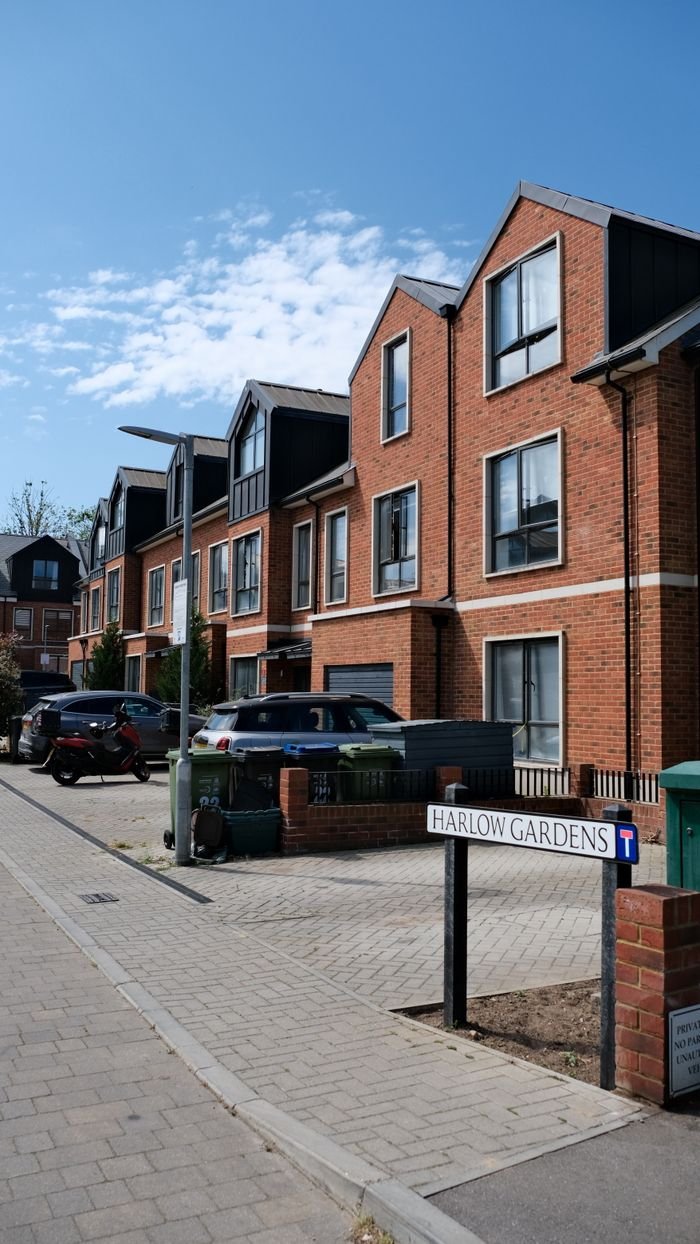 Capture of a modern housing development on Harlow Gardens with clear skies.