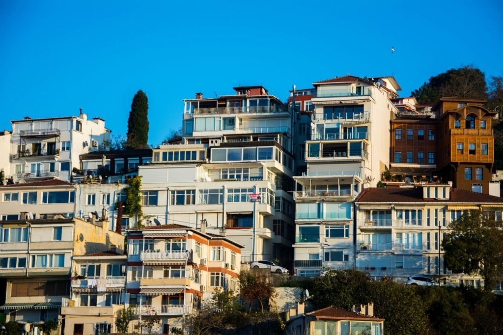 Captivating view of hillside residential buildings under a vibrant blue sky, showcasing modern architectural design.